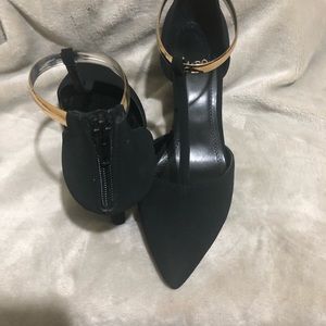 Black pumps with gold embellishments